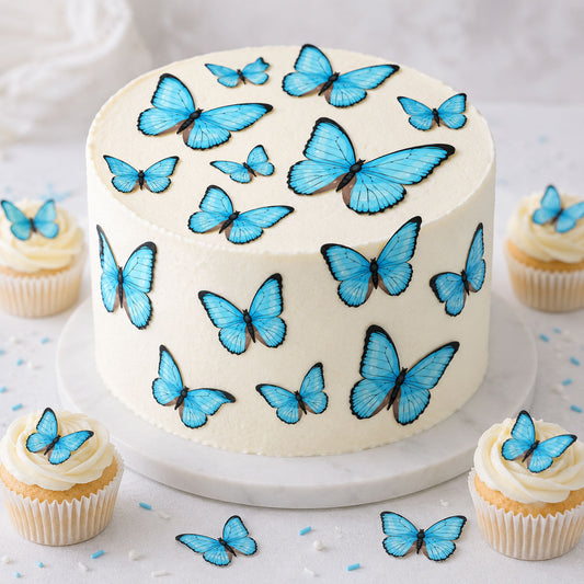 Blue butterfly cake toppers on a white cake and cupcakes, edible butterflies in multiple sizes