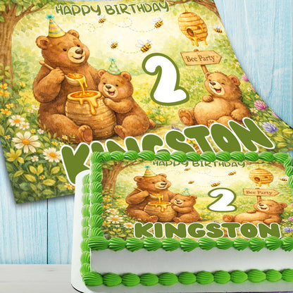 Close-up of bee themed bear birthday cake topper with honey jar, bees and custom name Kingston