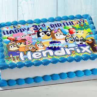 Colorful puppy-themed edible cake topper on a kids birthday cake with blue frosting