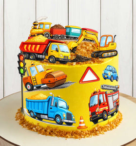 Construction vehicles edible cake toppers on yellow birthday cake with dump truck, excavator, road roller and fire truck