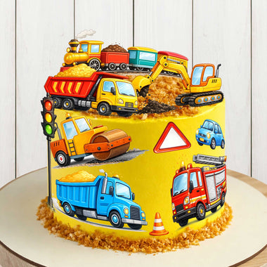 Construction vehicles edible cake toppers on yellow birthday cake with dump truck, excavator, road roller and fire truck