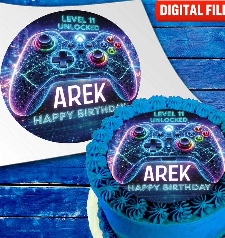 Neon gamer cake topper with glowing game controller and name on blue birthday cake