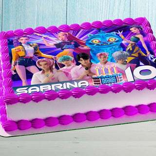 Anime-style K-Pop characters edible cake topper on a pink decorated kids birthday cake