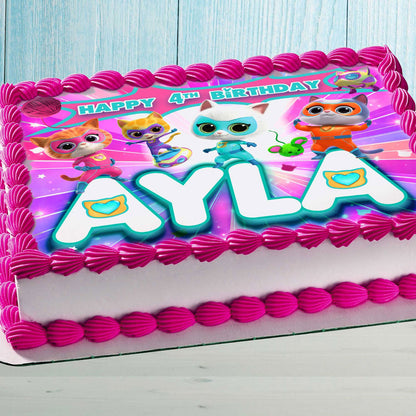 Personalized Kitty Superhero edible cake topper with custom name and age on a sheet cake with pink frosting.