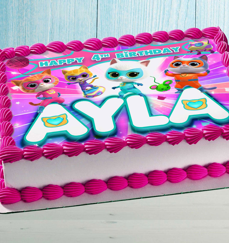 Personalized Kitty Superhero edible cake topper with custom name and age on a sheet cake with pink frosting.