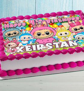 Birthday cake with colorful cute monster topper design and child's name in bright colors