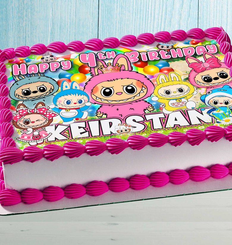 Birthday cake with colorful cute monster topper design and child's name in bright colors