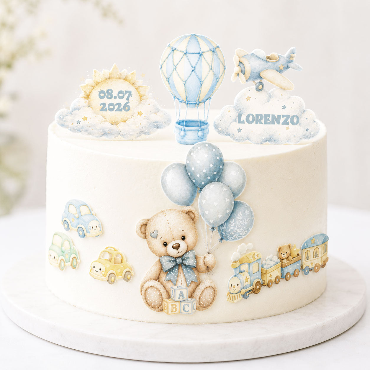 Personalized teddy bear travel edible topper set displayed on a birthday cake