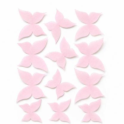 Flat lay of 12 pink wafer paper butterflies in three sizes arranged on a white background, what you receive