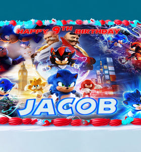 Sonic themed edible cake topper on a birthday cake with bright blue border frosting