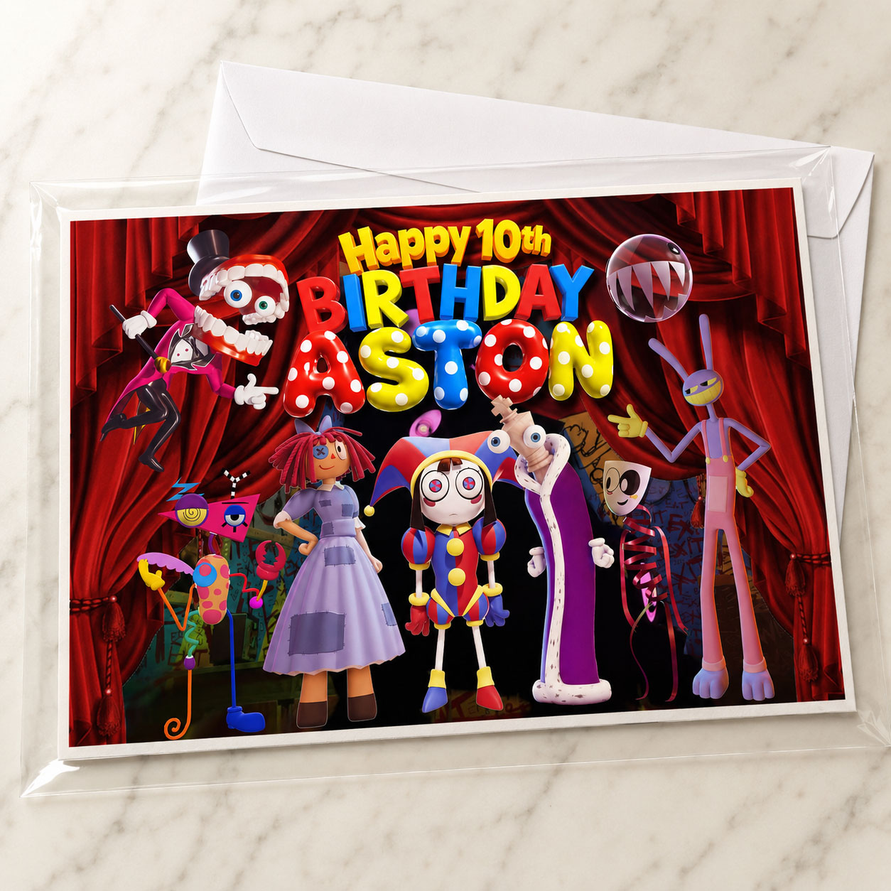 Amazing Digital Circus edible cake topper packaging photo showing flat mail-ready protective envelope