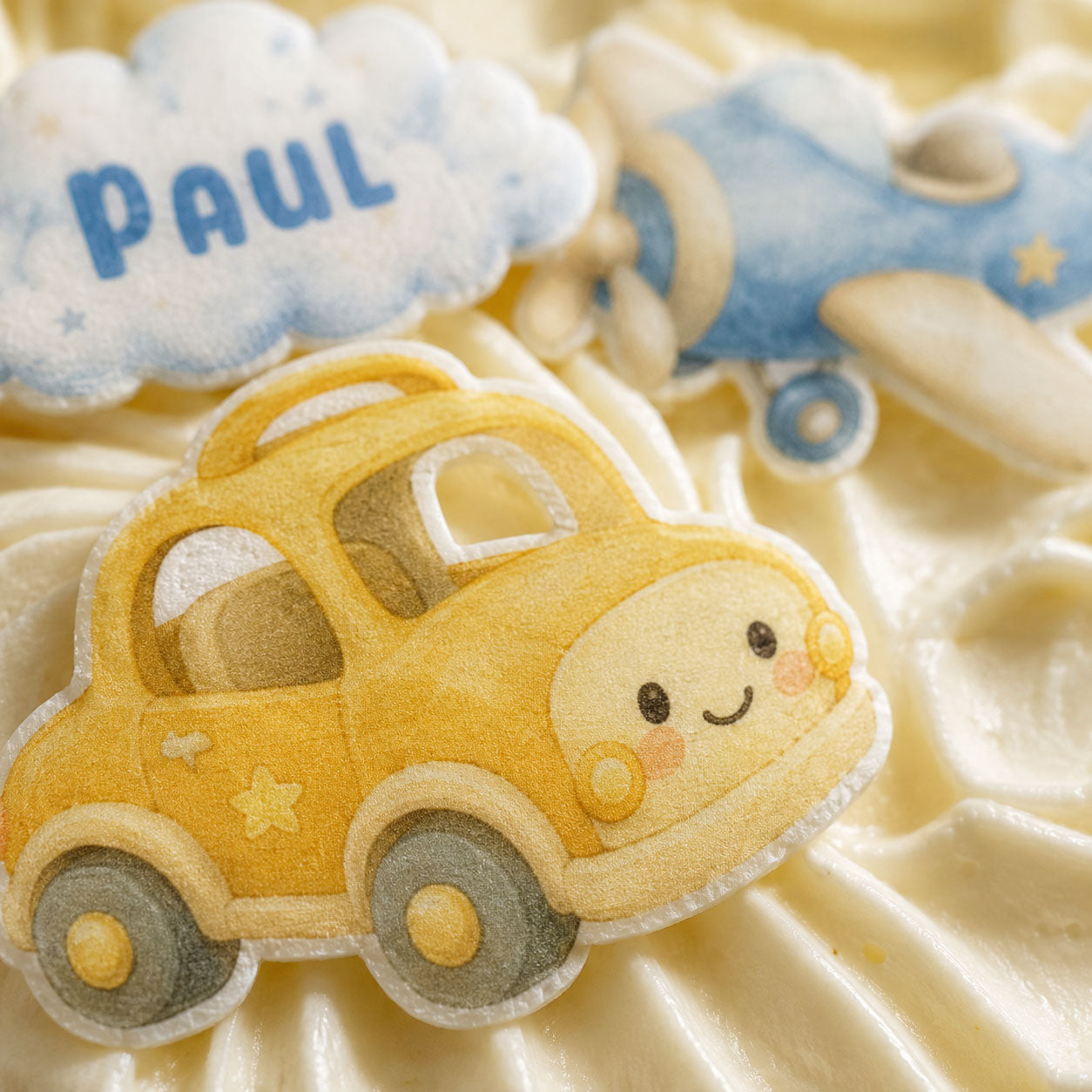 Close-up of baby boy edible cupcake topper printed on sugar sheet with soft blue details