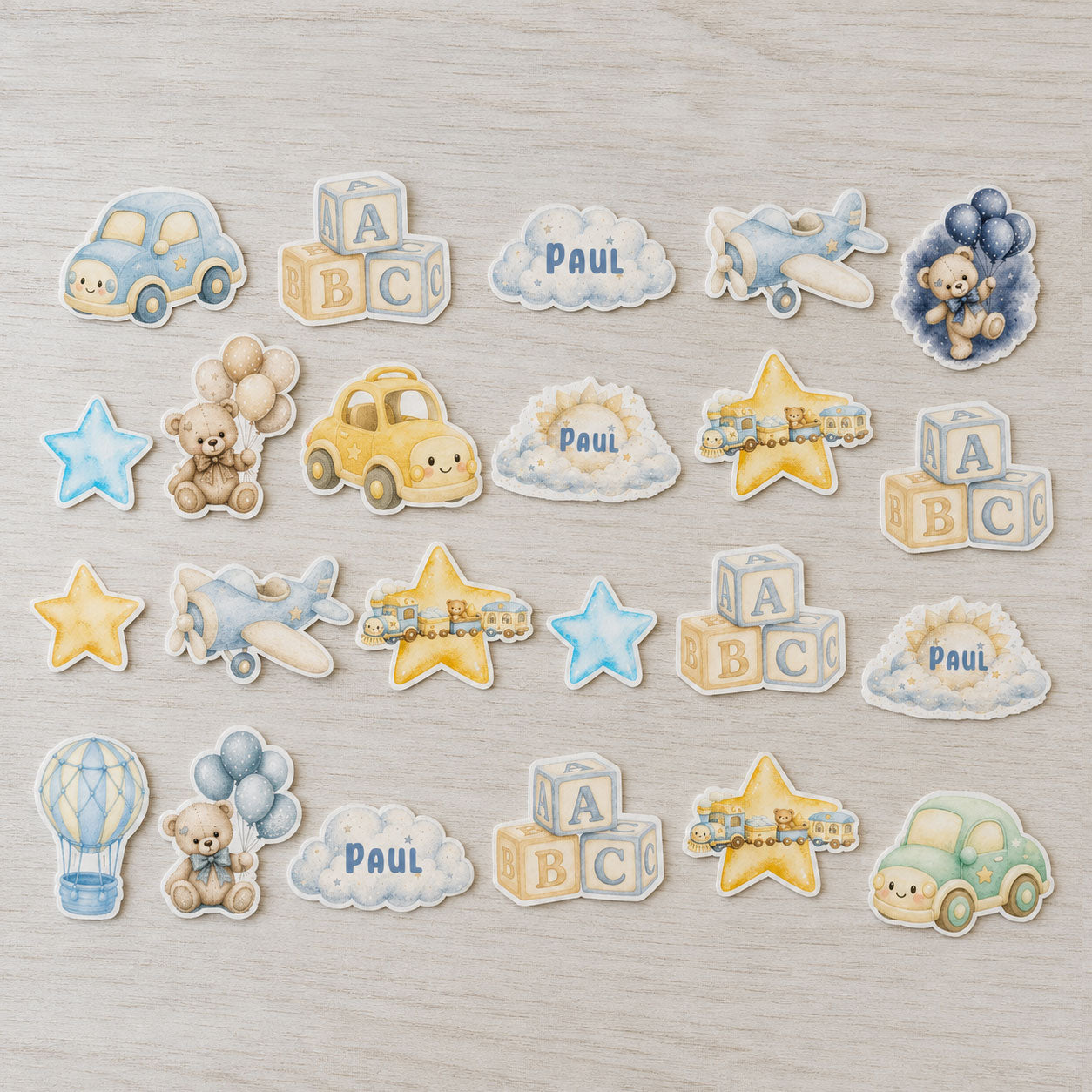 Baby boy edible cupcake topper set flat lay with cars, planes and teddy bear decorations