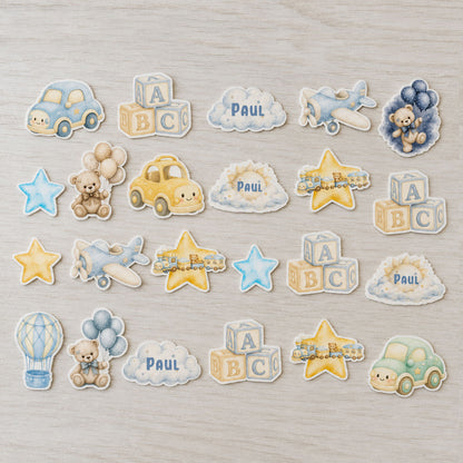 Baby boy edible cupcake topper set flat lay with cars, planes and teddy bear decorations