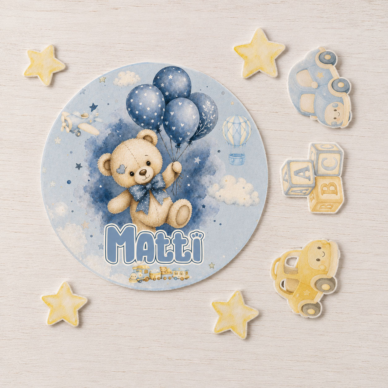 Baby boy teddy bear edible topper set flat lay with balloon and star cake decorations