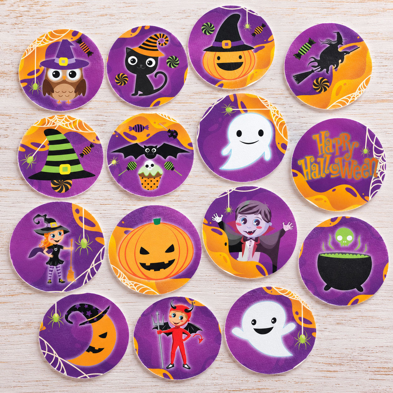 Halloween edible cake toppers flat lay with witch owl, black cat, pumpkin and ghost designs