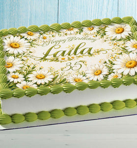 Personalized daisy edible cake topper with custom name on birthday cake floral decoration