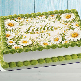 Personalized daisy edible cake topper with custom name on birthday cake floral decoration