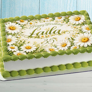 Personalized daisy edible cake topper with custom name on birthday cake floral decoration