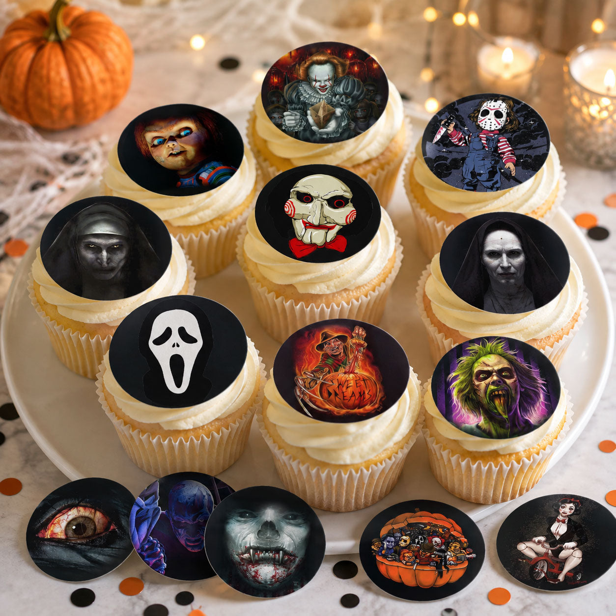 Horror movie themed edible cupcake toppers arranged on a plate of frosted cupcakes