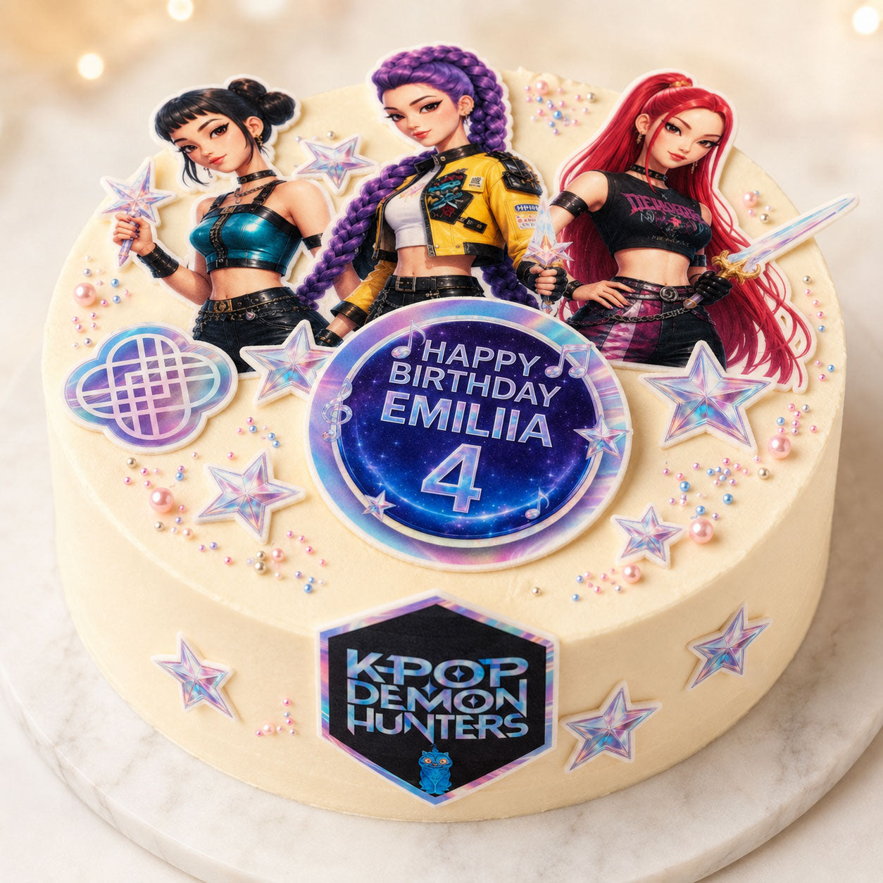K-Pop idol group edible cake topper scene on a frosted cake with personalized birthday name and stars