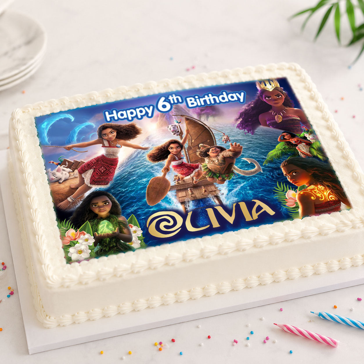 Moana birthday edible cake topper personalized with name and age on a rectangular cake