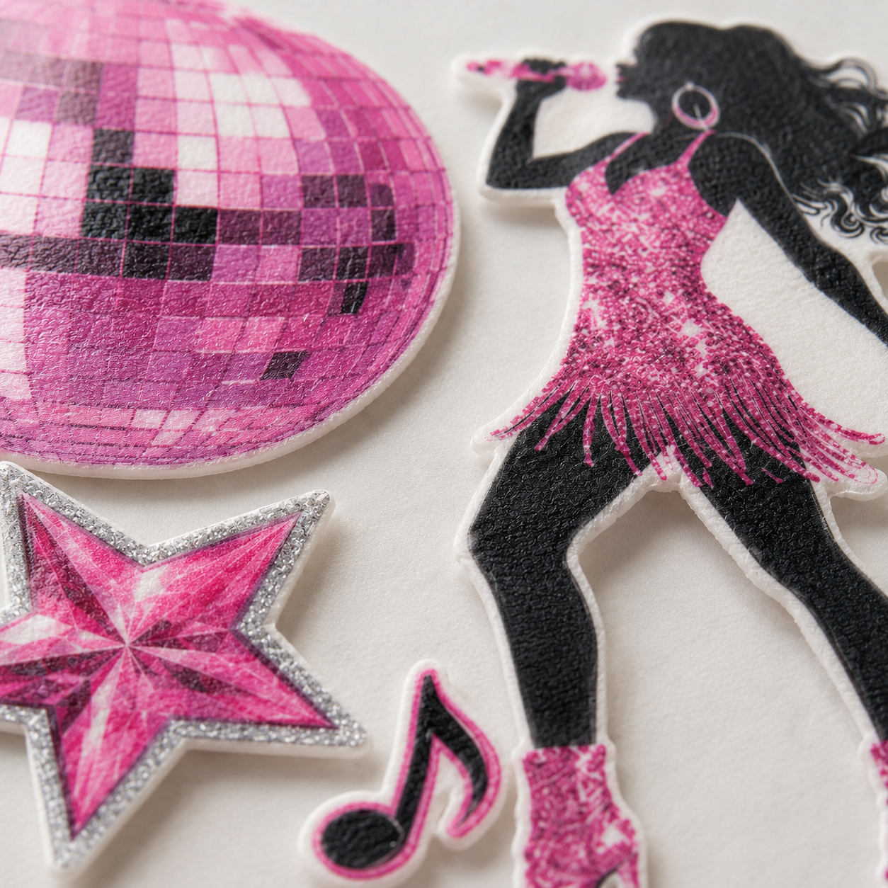 Close-up of disco dance party edible cake topper showing a singer figure, disco ball and star detail